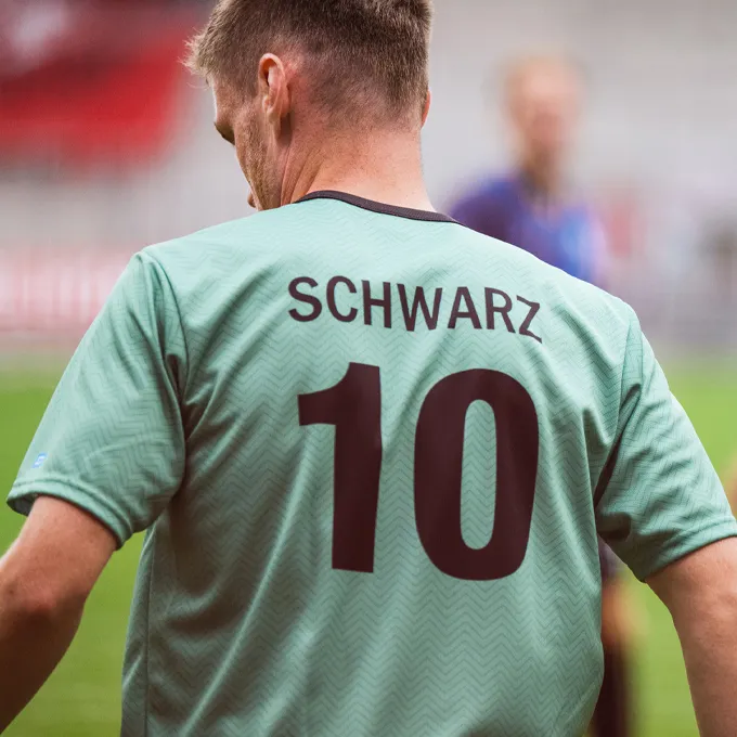 A player is wearing a mint green soccer jersey featuring the number 10 and the name 'SCHWARZ' on the back.